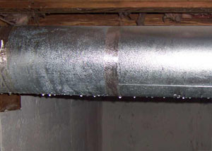 condensation collecting on an HVAC vent in a humid Santa Paula basement