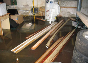 A severely flooding basement in Oak View, with lumber and personal items floating in a foot of water
