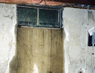 Water pouring out from a basement window in Carpinteria